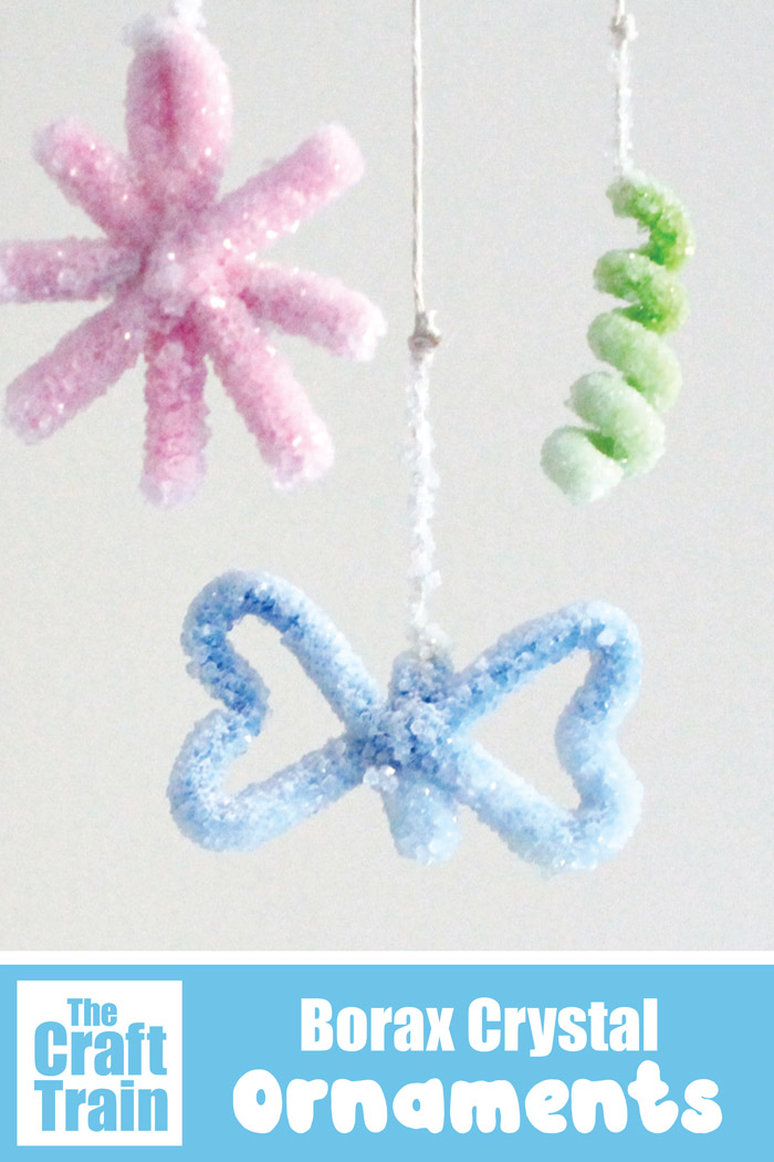 Gorgeous borax crystal ornaments hanging. This is a fun Christmas science project for kids #borax #boraxcrystals #scienceforkids #stem #stemcrafts #steam #crystalmaking #crystals #science #thecrafttrain