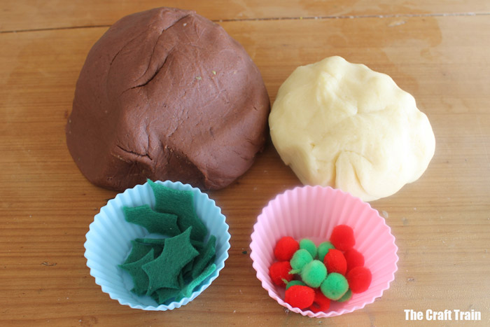 dough set out with felt leaves and pom poms