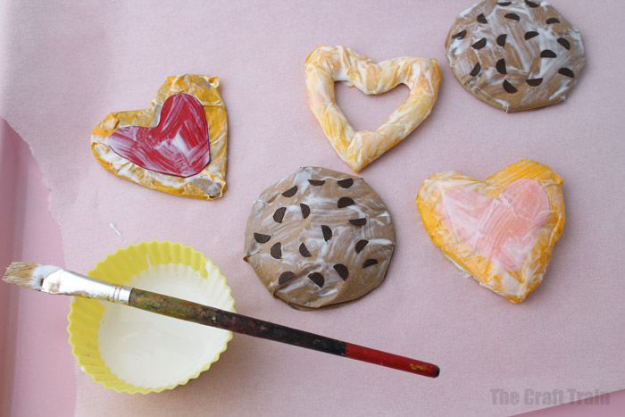 painting the paper cookies with mod podge