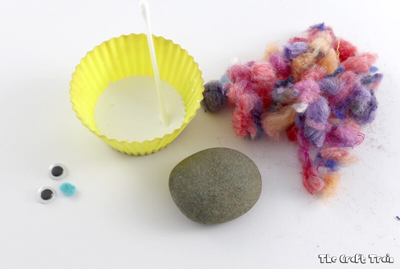Create adorable fluffy rocks with yarn pom pom trimmings