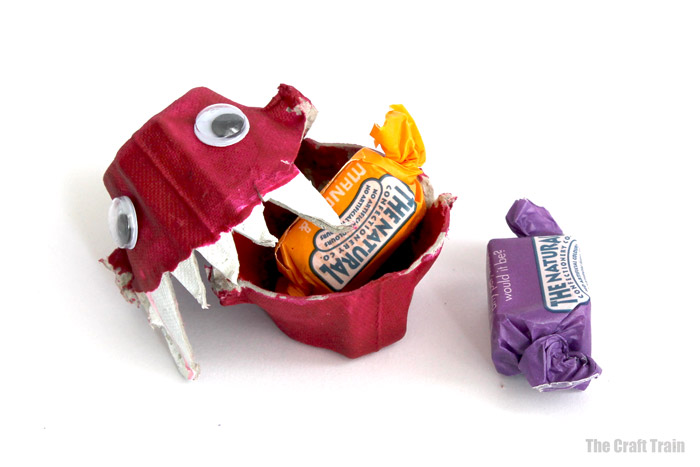 Monster treat holder with a sweet inside the mouth