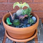 Dinosaur succulent garden kids can make. This would make a great Spring gardening project for kids, and could also be used as a small world for imaginary play #dinosaurs #dinosaurgarden #gardeningforkids #succulentgarden #smallworld
