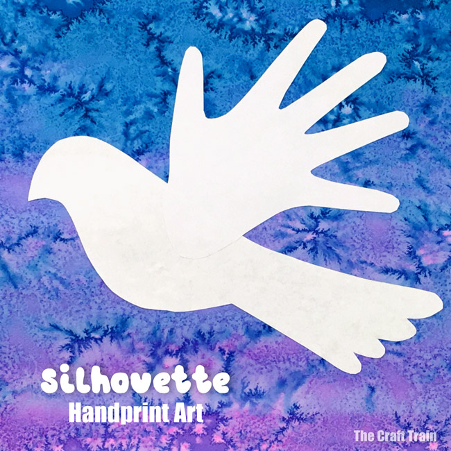 Peace dove handprint art. Create a process art background using liquid watercolour and salt, then use the printable template and handprint shapes to create the silhouette art #christmas #christmasart #handprint #handprintart #dove #peacedove