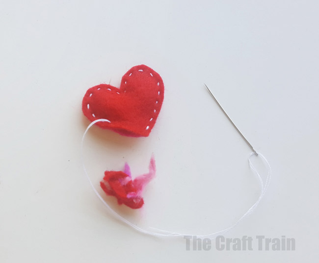 Step 6 - mini valentine matchbox craft for kids. Make the most adorable mini hand-sewn plushy heart delivered in a cute matchbox #valentine #valentinesday #matchboxcraft #kidssewing #felt #kidscraft