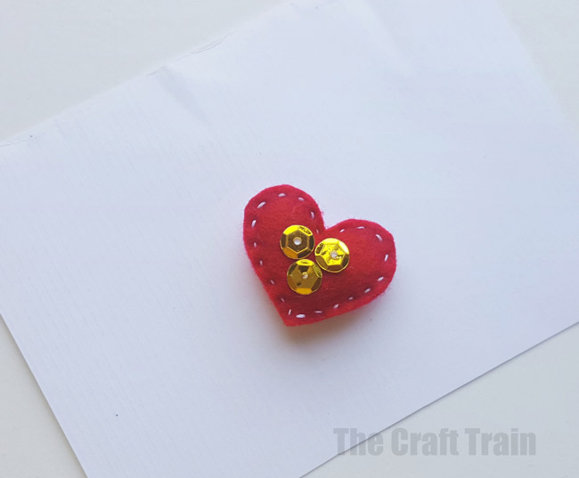 Step 7 - mini valentine matchbox craft for kids. Make the most adorable mini hand-sewn plushy heart delivered in a cute matchbox #valentine #valentinesday #matchboxcraft #kidssewing #felt #kidscraft