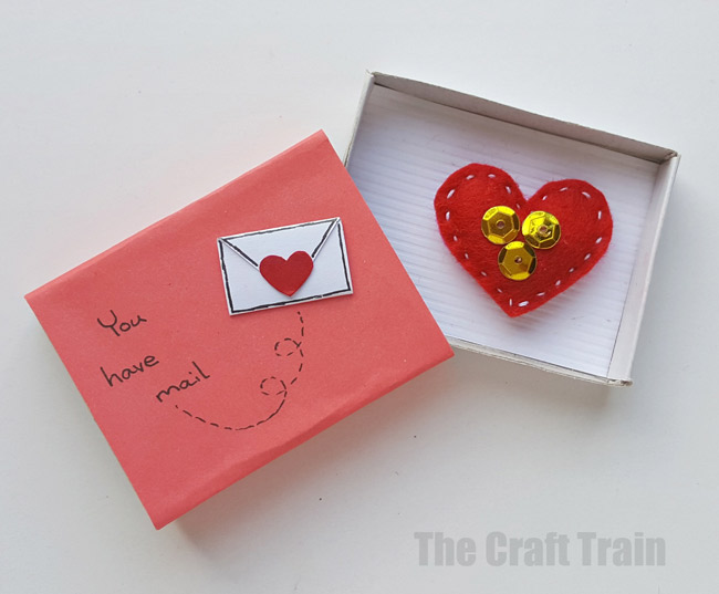 Step 8 - mini valentine matchbox craft for kids. Make the most adorable mini hand-sewn plushy heart delivered in a cute matchbox #valentine #valentinesday #matchboxcraft #kidssewing #felt #kidscraft
