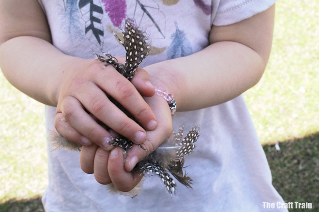 gathering feathers to make rock chicks #naturecraft #kidscrafts #outdoorkids