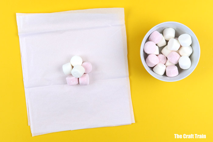 Place the marshmallows onto the tissue paper square