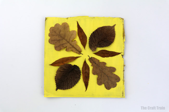 arrange your dried leaves into a design before gluing into place