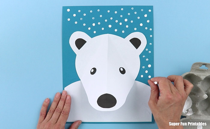 painting Q-tip snow around the polar bear craft for kids