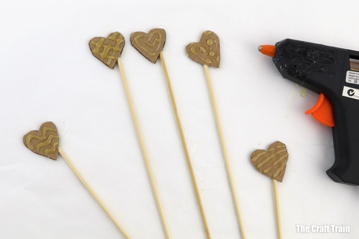 decorate the hearts with hot glue gun patterns to create texture
