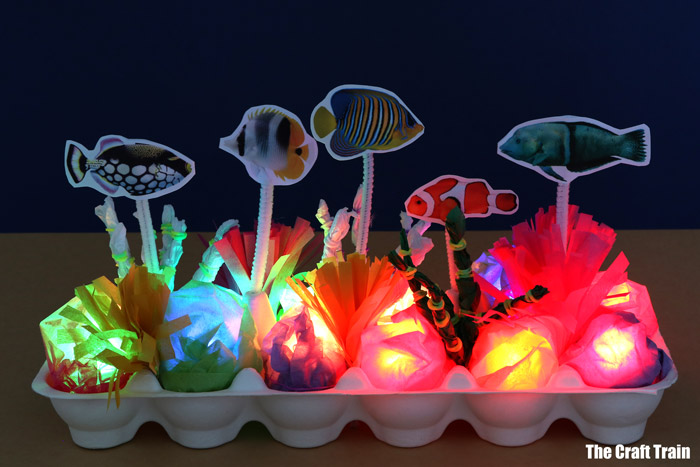 Light up tropical reef craft idea for kids. This egg carton reef lights up in the dark