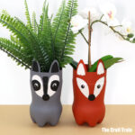 woodland animal planters made from recycled plastic bottles in a fox and raccoon design