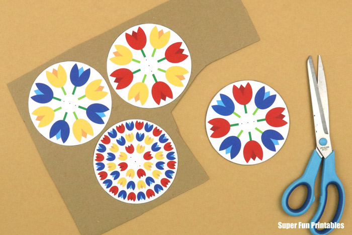 glue spinner shapes to recycled card stock