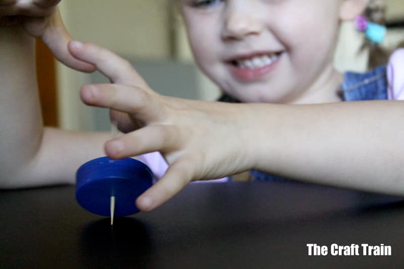 kid playing with spinning top