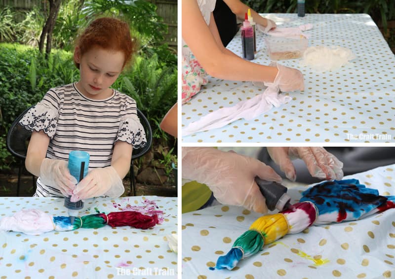 how to tie dye: kids tie dying shirts outdoors