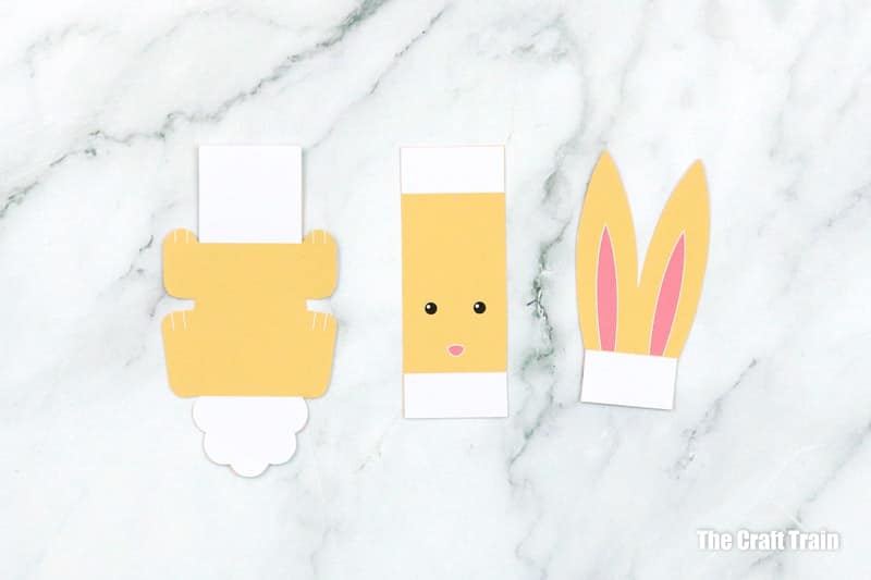 Bunny shapes ready to make a yellow pom pom bunny