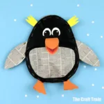 stuffed paper penguin craft for kids. This cute and totally squishy penguin is made from a recycled grocery bag that's been stuffed with newspaper