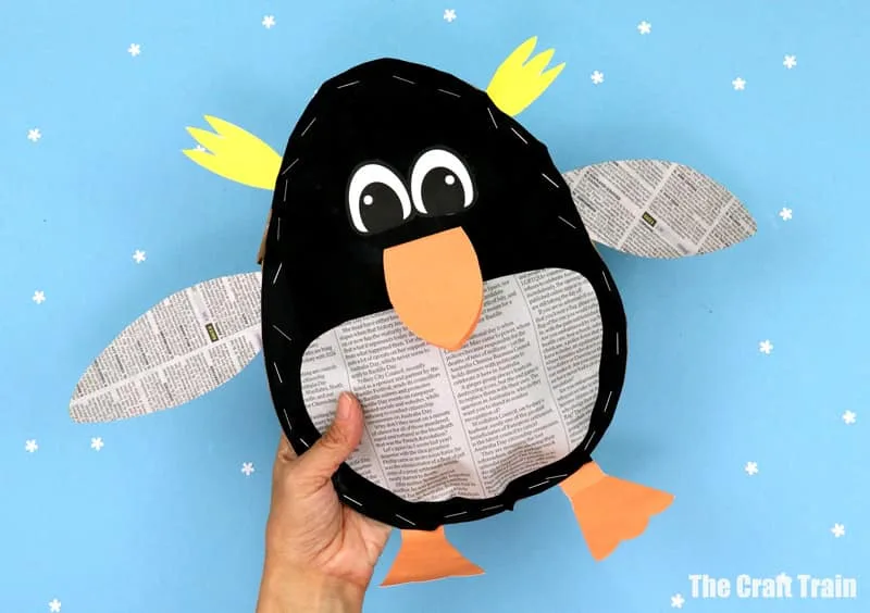 stuffed paper penguin craft for kids. This cute and totally squishy penguin is made from a recycled grocery bag that's been stuffed with newspaper