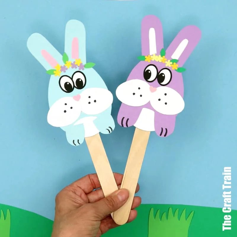 Easter bunny stick puppets made from paper egg shapes with paper cut details glued on. Such a fun craft for kids to make at Easter!